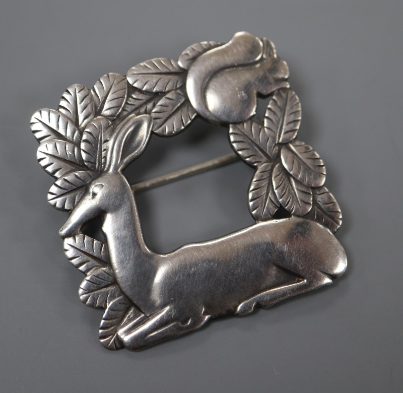 A post 1945 Georg Jensen 925 square recumbent deer and squirrel brooch, design no. 318, 37mm, 15 grams.